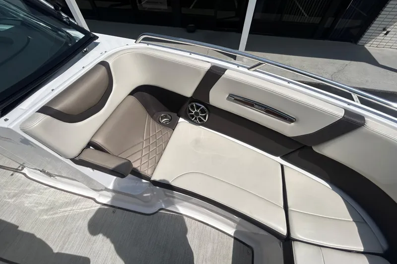 Slide: The Image of Luxurious seating area on a 2018 Chaparral 267 SSX boat, featuring elegant upholstery and speaker system. - 17