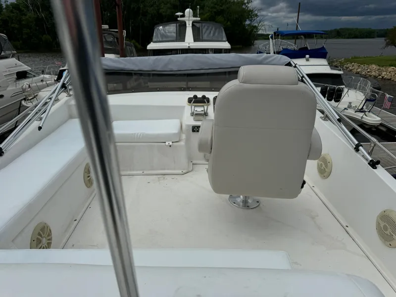 Slide: The Image of 2008 Holiday Mansion 37 boat deck with white seating and steering chair. - 10