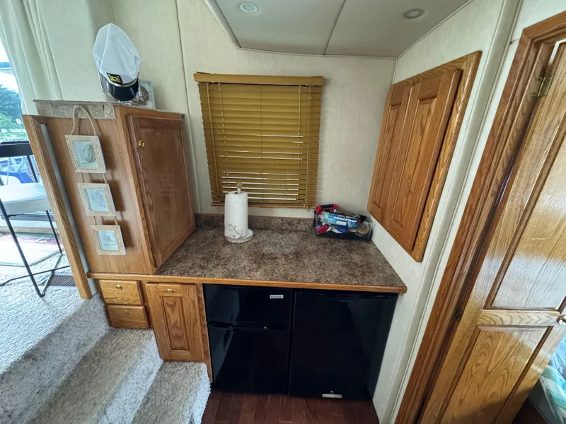 Slide: The Image of Interior of 2008 Holiday Mansion 37 with wooden cabinets and countertop. - 19