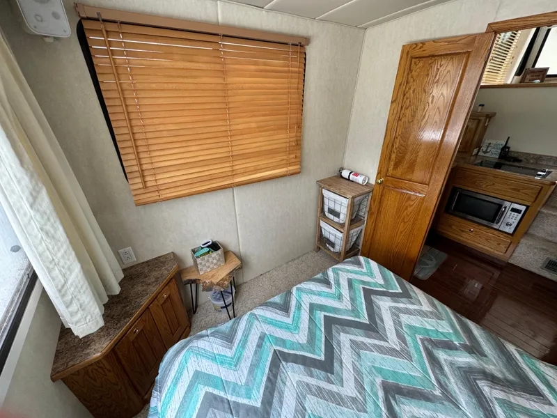 Slide: The Image of Cozy interior of 2008 Holiday Mansion 37 with bed, wooden blinds, and kitchenette. - 22