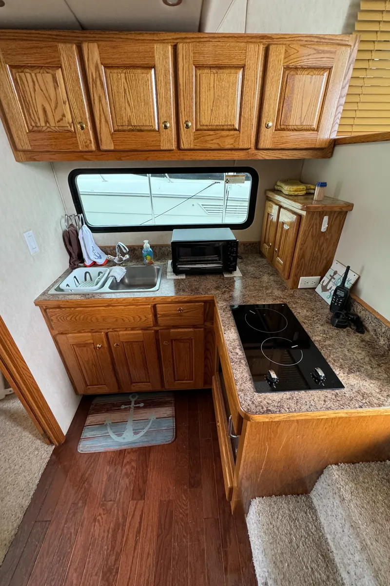 Slide: The Image of Compact kitchen in 2008 Holiday Mansion 37 with wooden cabinets and modern appliances. - 24