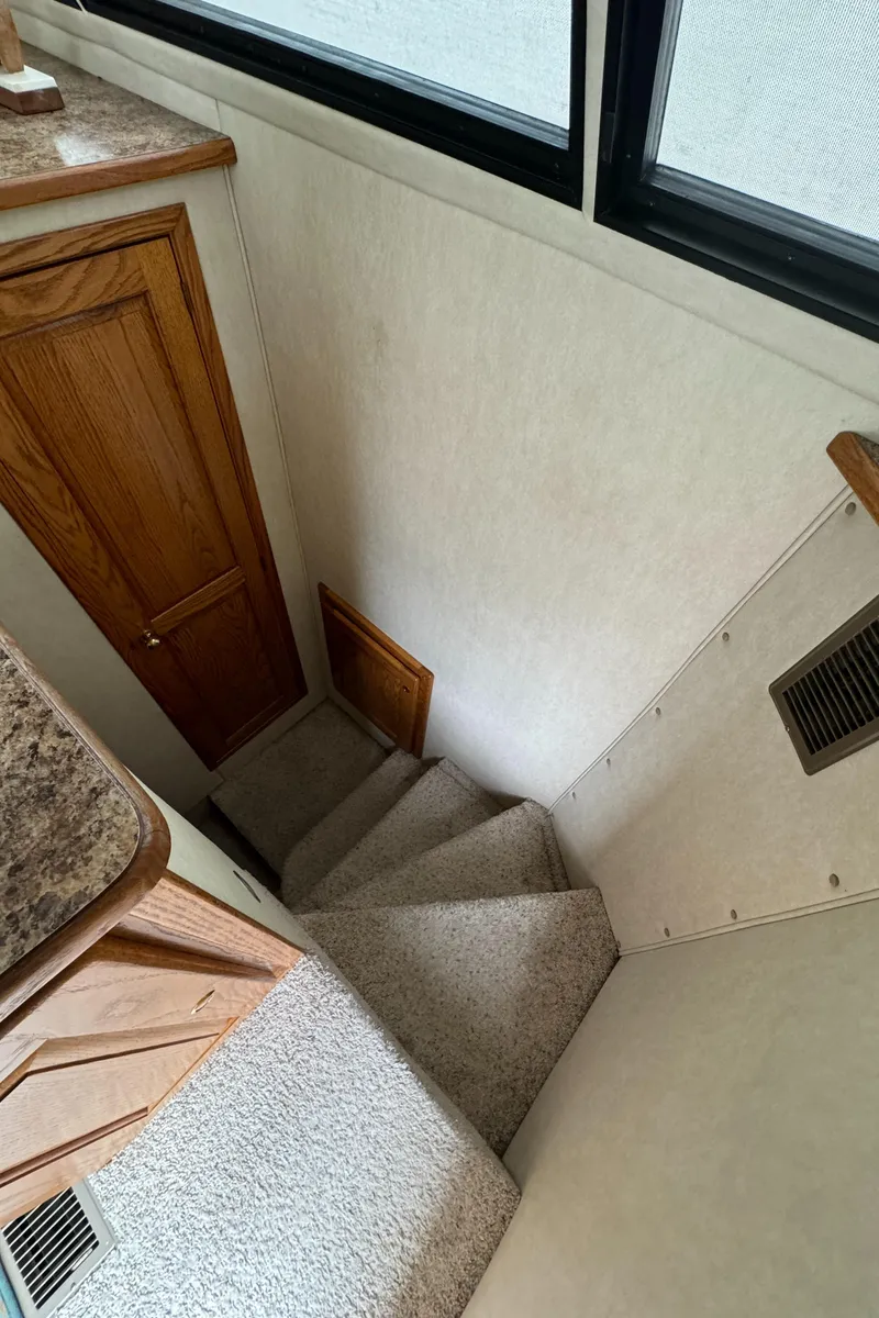 Slide: The Image of Staircase inside 2008 Holiday Mansion 37 boat, featuring carpeted steps and wooden accents. - 26