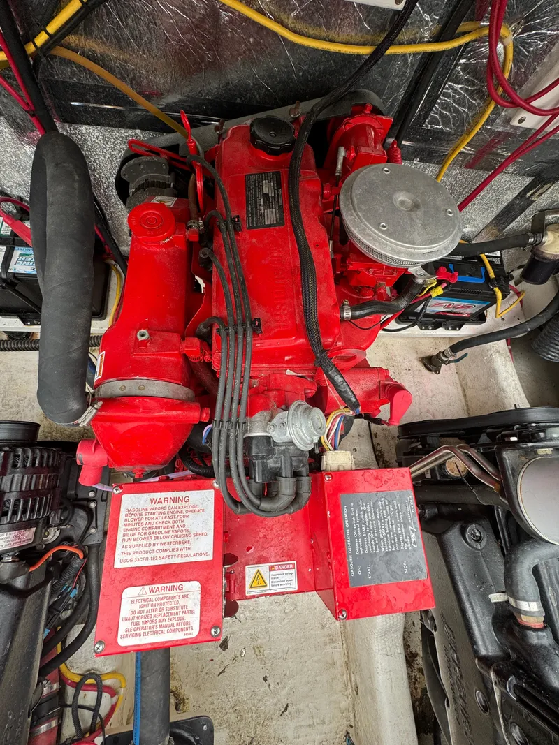 Slide: The Image of Engine compartment of a 2008 Holiday Mansion 37 boat with red engine components. - 37