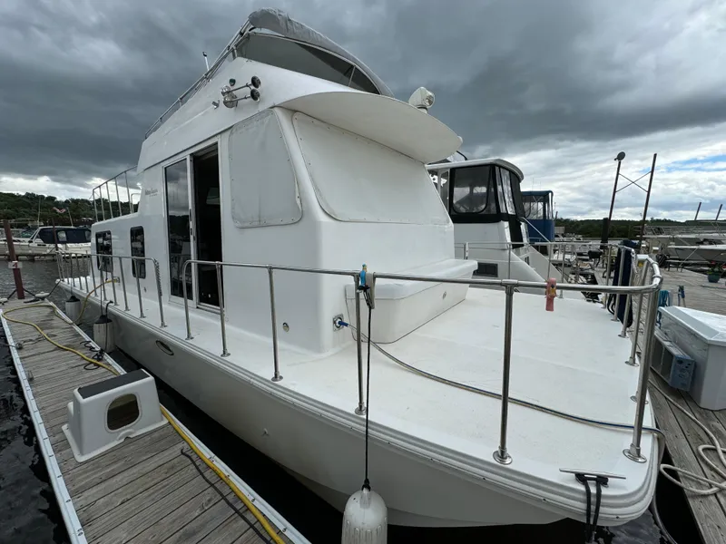 Slide: The Image of 2008 Holiday Mansion 37 houseboat docked under cloudy skies. - 5