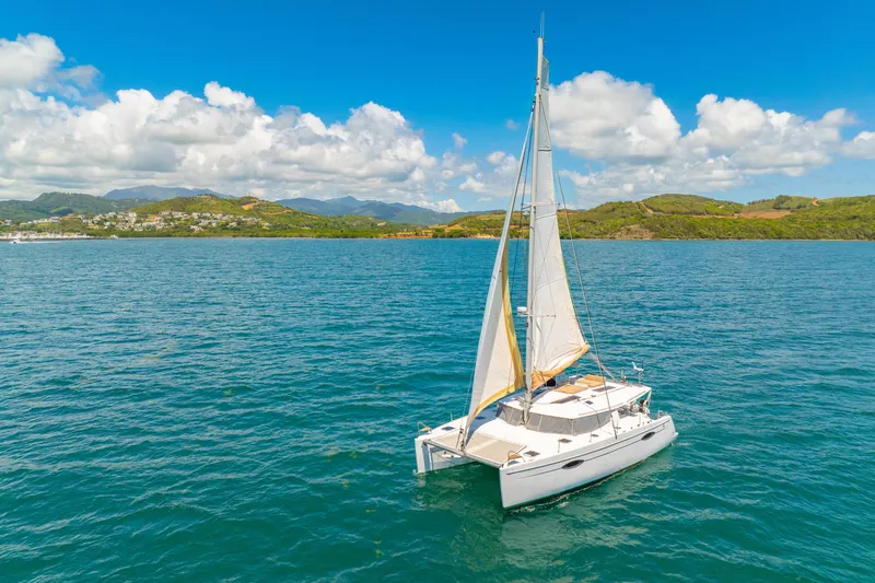 Slide: The Image of 2014 Fountaine Pajot Helia 44 catamaran sailing on blue ocean under clear sky. - 1