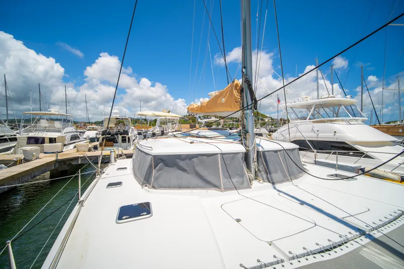 Slide: The Image of 2014 Fountaine Pajot Helia 44 catamaran docked at marina under clear blue sky. - 10