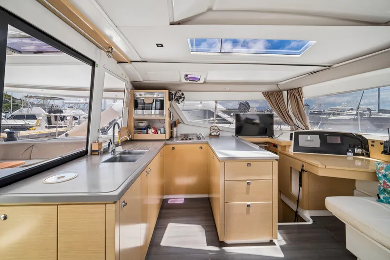 Slide: The Image of Interior of 2014 Fountaine Pajot Helia 44 catamaran with modern kitchen and navigation area. - 17