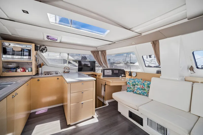 Slide: The Image of Interior of 2014 Fountaine Pajot Helia 44 catamaran with modern kitchen and seating area. - 21