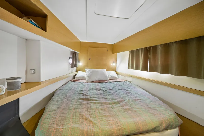 Slide: The Image of Cozy bedroom interior of 2014 Fountaine Pajot Helia 44 catamaran with wooden accents. - 25