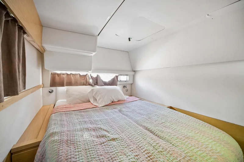 Slide: The Image of Cozy bedroom in 2014 Fountaine Pajot Helia 44 catamaran with colorful bedding and natural light. - 26