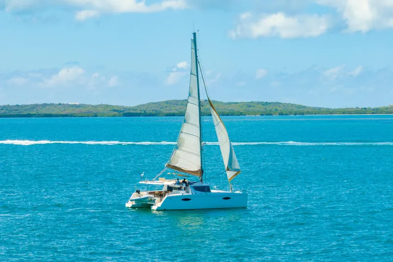 The Image of Sailing catamaran Fountaine Pajot Helia 44, 2014 model, cruising on blue ocean waters. - 3