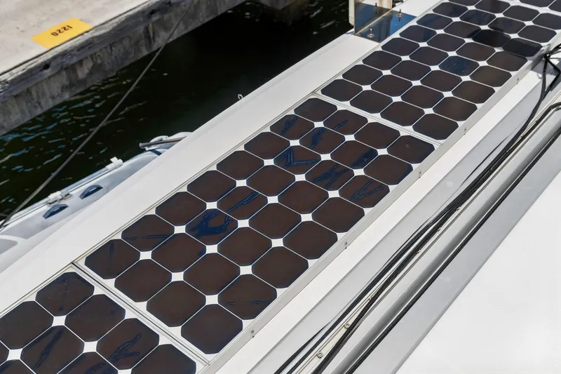 Slide: The Image of Solar panels on a 2014 Fountaine Pajot Helia 44 catamaran, docked at a marina. - 38
