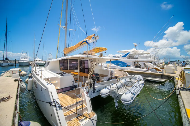 Slide: The Image of 2014 Fountaine Pajot Helia 44 catamaran docked at marina under clear blue sky. - 4