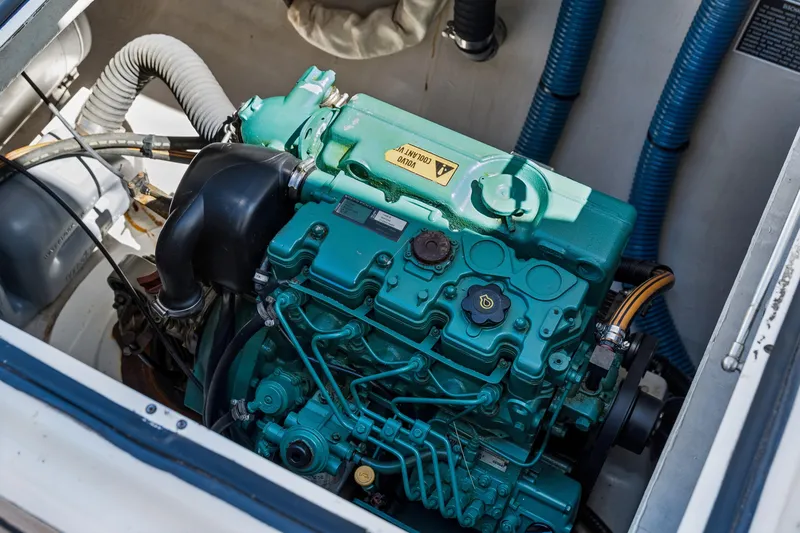 Slide: The Image of Engine compartment of a 2014 Fountaine Pajot Helia 44 catamaran, showcasing a green marine engine. - 44