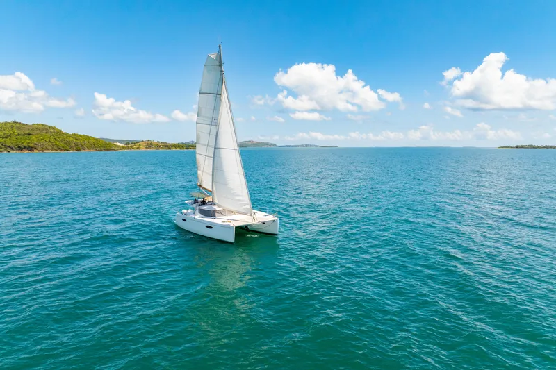 Slide: The Image of Sailing catamaran Fountaine Pajot Helia 44, 2014, on open sea under clear blue sky. - 49