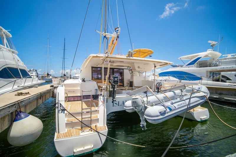 Slide: The Image of 2014 Fountaine Pajot Helia 44 catamaran docked with inflatable dinghy attached. - 5