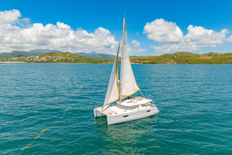 Slide: The Image of Sailing catamaran Fountaine Pajot Helia 44, 2014 model, on serene blue waters. - 51