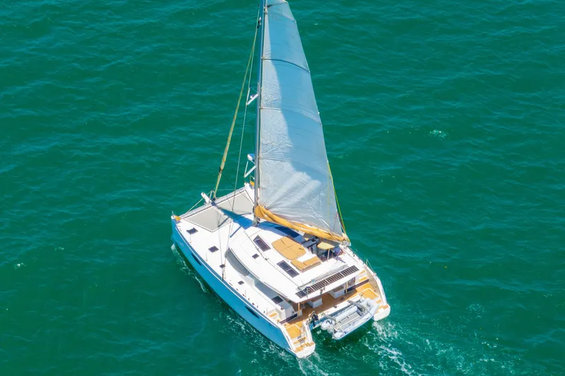 Slide: The Image of 2014 Fountaine Pajot Helia 44 catamaran sailing on clear blue waters. - 61