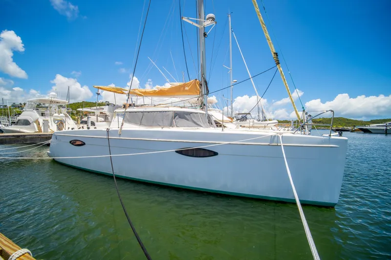 Slide: The Image of 2014 Fountaine Pajot Helia 44 catamaran docked in a sunny marina. - 9