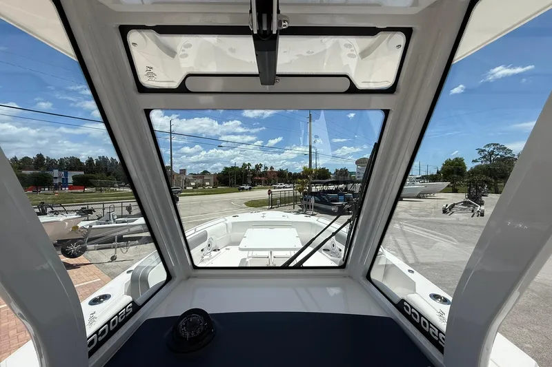 Slide: The Image of Interior view of 2026 Edgewater 250CC boat, showcasing windshield and dashboard. - 11