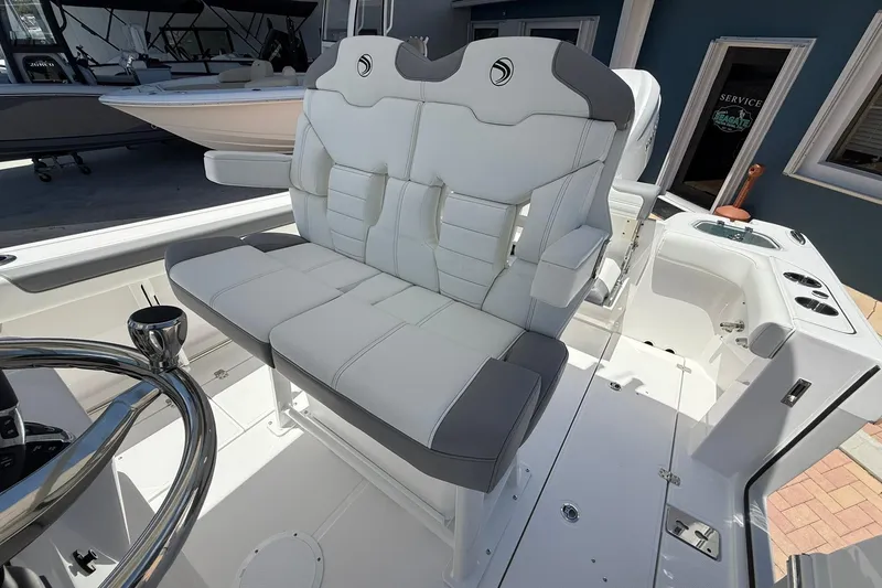 Slide: The Image of 2026 Edgewater 250CC boat interior with plush white seating and modern helm design. - 13
