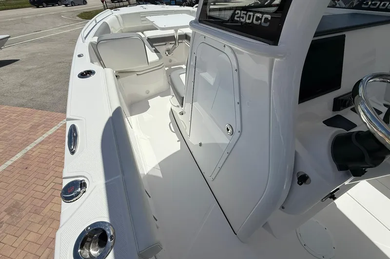 Slide: The Image of 2026 Edgewater 250CC boat interior with sleek white design and modern controls. - 14