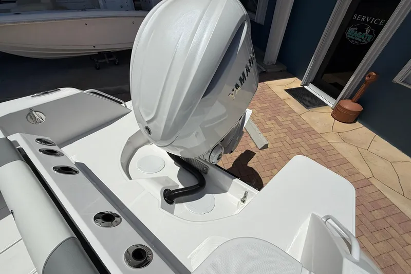 Slide: The Image of Edgewater 250CC 2026 boat with Yamaha outboard motor, docked near service area. - 5