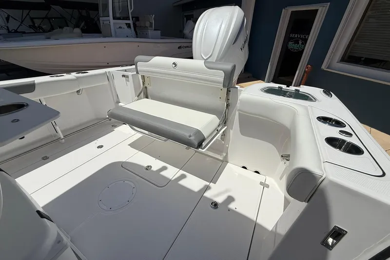 Slide: The Image of 2026 Edgewater 250CC boat interior with seating and cup holders, showcasing modern design. - 9