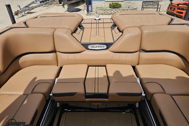 Slide: The Image of 2022 Supra SE 550 boat interior with tan leather seating and sleek design. - 103