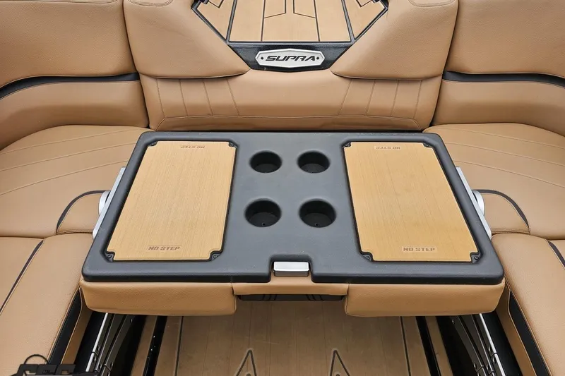 Slide: The Image of 2022 Supra SE 550 boat interior with tan seating and integrated cup holders. - 106