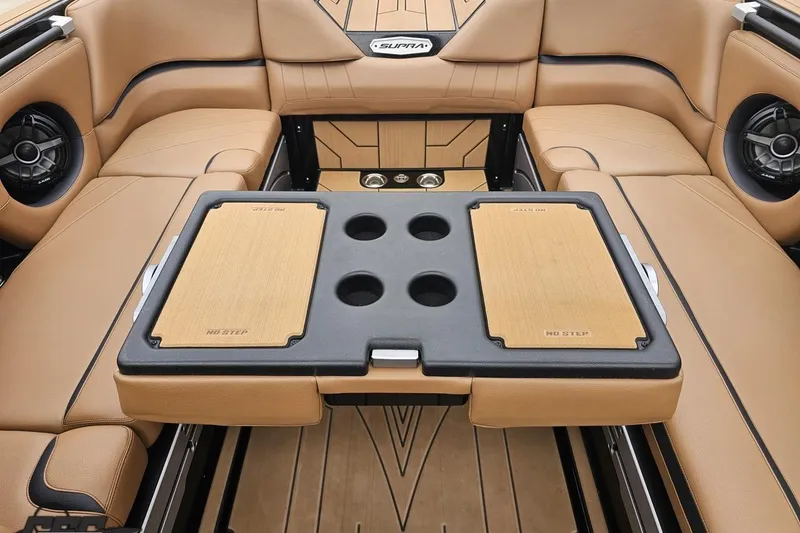 Slide: The Image of 2022 Supra SE 550 boat interior with tan seating and central table. - 107