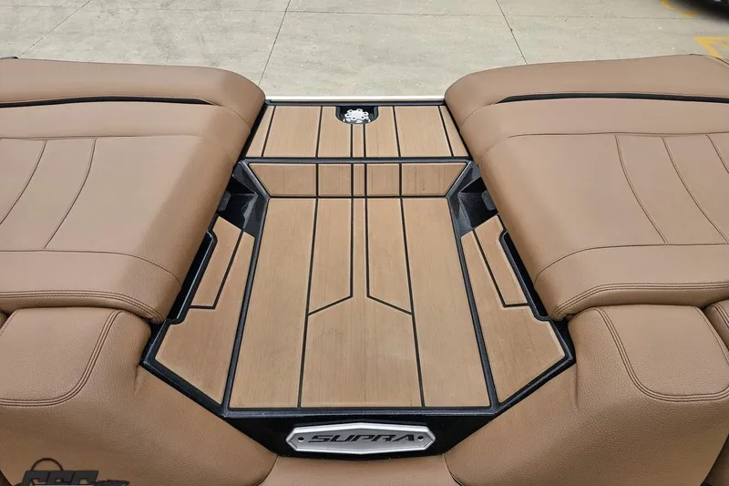 Slide: The Image of 2022 Supra SE 550 boat interior with tan leather seats and wood accents. - 109
