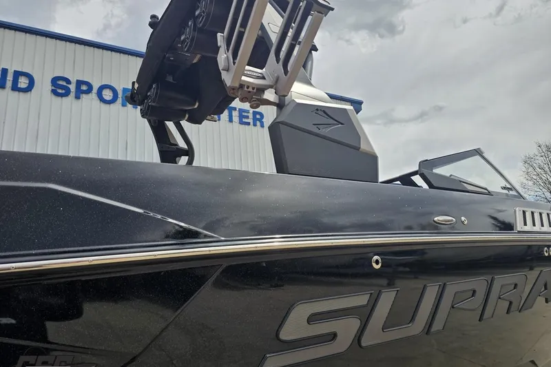 Slide: The Image of 2022 Supra SE 550 boat at dealership, showcasing sleek design and modern features. - 11