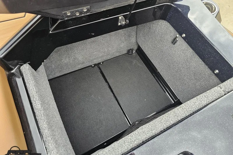 Slide: The Image of 2022 Supra SE 550 storage compartment with gray interior lining. - 115