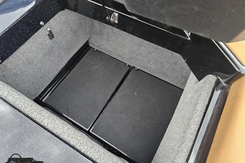 Slide: The Image of Storage compartment of 2022 Supra SE 550, featuring a spacious, carpeted interior. - 116