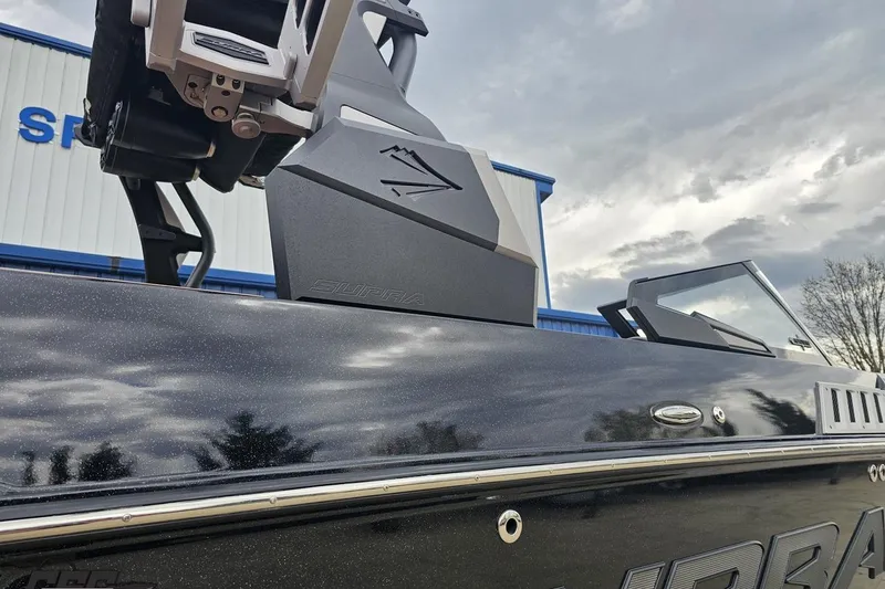 Slide: The Image of 2022 Supra SE 550 boat exterior with sleek design and modern detailing. - 12