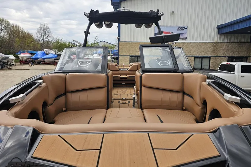 Slide: The Image of 2022 Supra SE 550 boat interior with tan leather seating and modern design. - 18