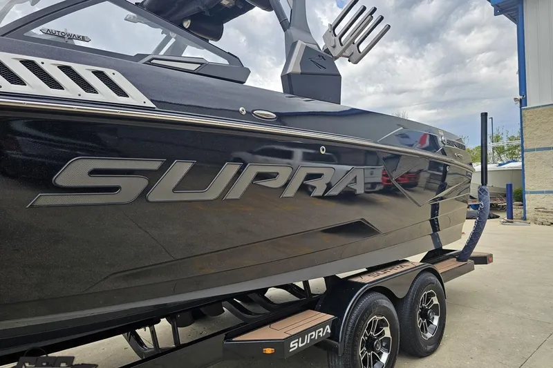 Slide: The Image of 2022 Supra SE 550 boat on trailer, showcasing sleek design and branding. - 24