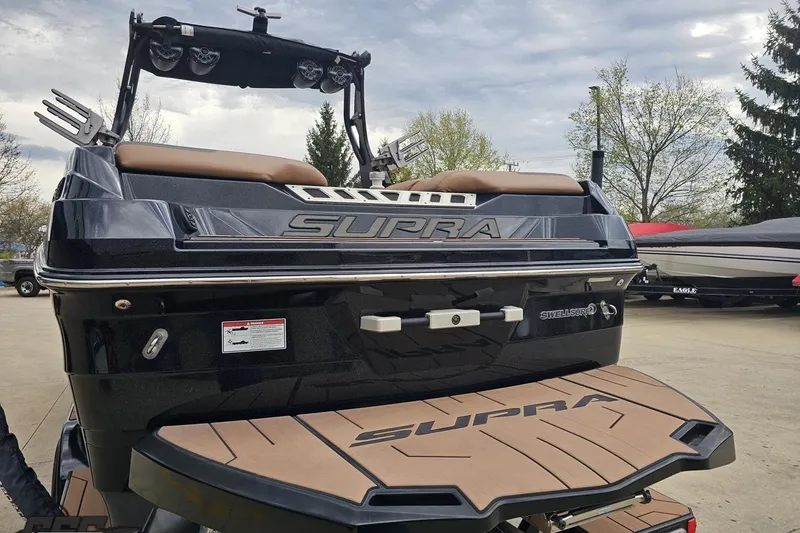 Slide: The Image of 2022 Supra SE 550 boat rear view with Swell Surf system and teak deck. - 32