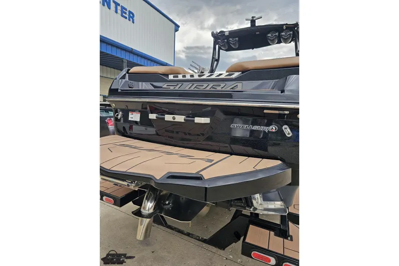 Slide: The Image of 2022 Supra SE 550 boat rear view with swim platform and Swell Surf system. - 35