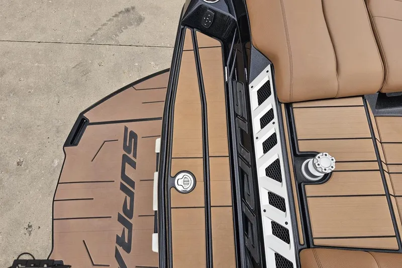Slide: The Image of 2022 Supra SE 550 boat deck with brown seating and sleek design. - 38