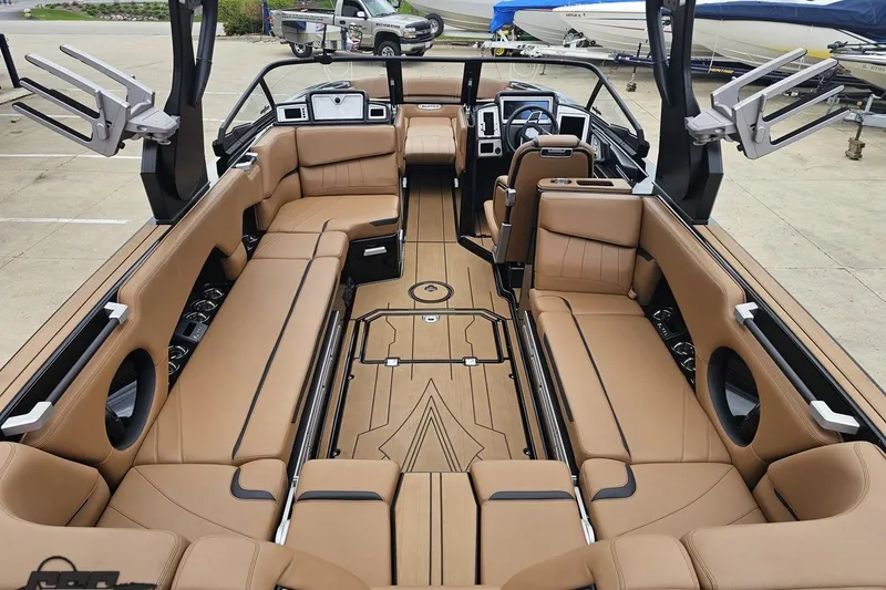 Slide: The Image of Luxurious interior of a 2022 Supra SE 550 boat with tan leather seating. - 43