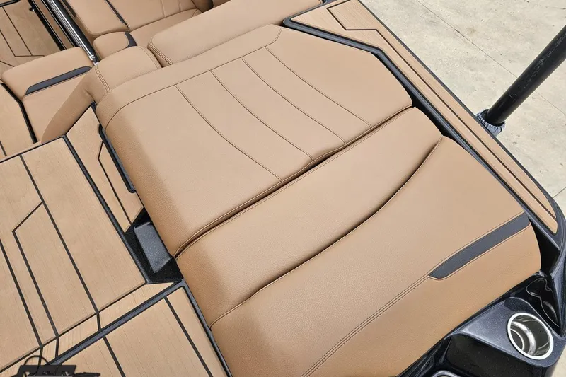 Slide: The Image of 2022 Supra SE 550 boat interior with tan leather seating and sleek design. - 46
