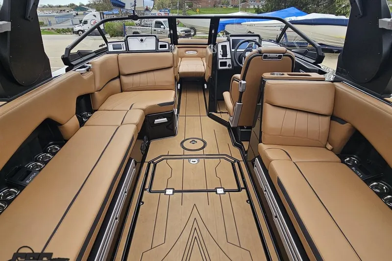 Slide: The Image of Luxurious interior of 2022 Supra SE 550 boat with tan leather seating and modern design. - 48