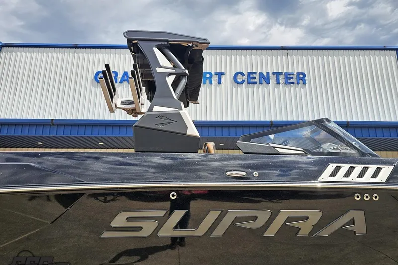 Slide: The Image of 2022 Supra SE 550 boat at dealership, showcasing sleek design and modern features. - 5