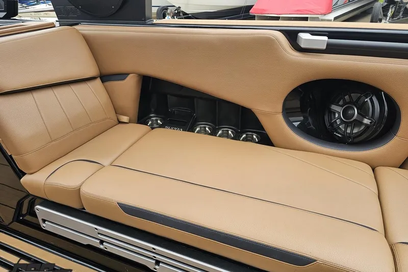 Slide: The Image of 2022 Supra SE 550 interior with tan leather seats and built-in speaker system. - 51