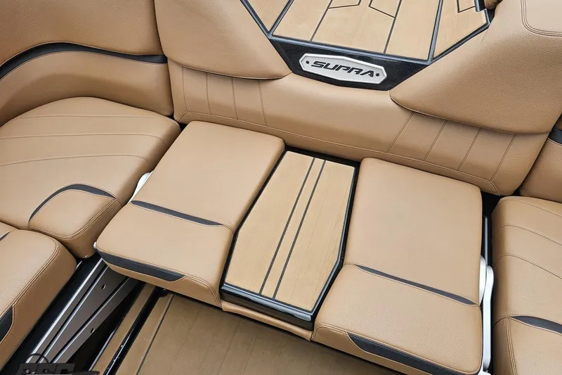 Slide: The Image of Luxurious tan leather interior of 2022 Supra SE 550 boat, featuring sleek design and comfort. - 52