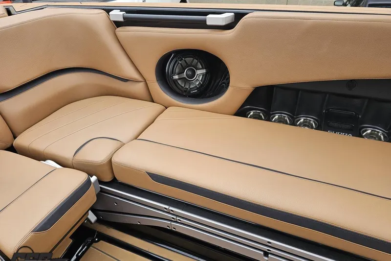 Slide: The Image of Luxurious tan interior of 2022 Supra SE 550 boat with speaker and cup holders. - 54