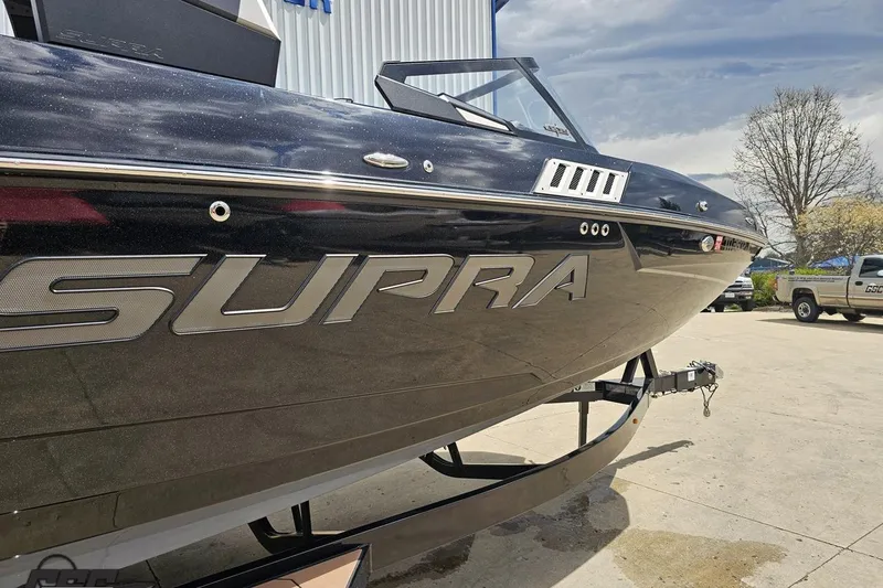 Slide: The Image of 2022 Supra SE 550 boat on trailer, showcasing sleek design and branding. - 6