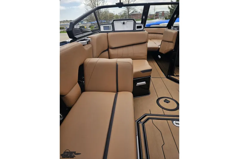 Slide: The Image of Luxurious interior of 2022 Supra SE 550 boat with tan leather seating. - 60